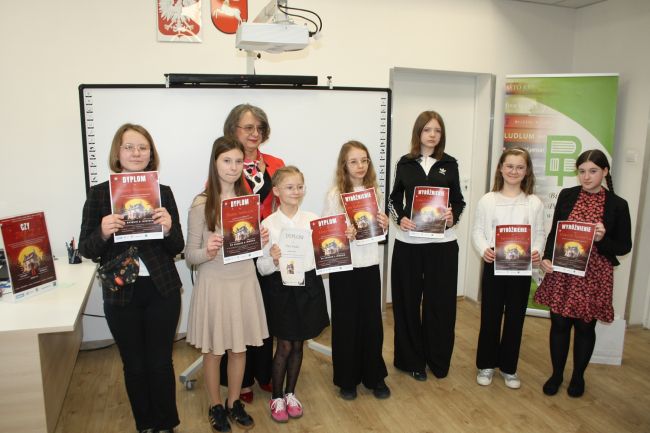 Siódemka laureatów konkursu wraz z dyrektorem Biblioteki Pedagogicznej.